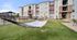 Modern apartment complex with inviting hammocks and a vibrant outdoor lounge area, perfect for relaxation and leisure.