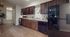 Chic apartment kitchen with sleek dark wood cabinets, modern appliances, and stylish decor.