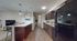 Modern open-concept kitchen and living area with a stylish island, sleek appliances, and cozy seating. Perfect for entertaining and relaxing.