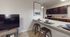 Modern kitchen space with elegant granite breakfast bar, stylish stools, and chic dining setup, perfect for casual dining and entertaining.