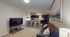 Inviting open-plan living space featuring a cozy lounge area and a modern kitchen with a stylish breakfast bar.