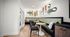 Chic and modern seating area featuring colorful wall art, cozy pillows, and sleek round tables, perfect for a stylish apartment ambiance.