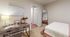 Cozy bedroom with warm lighting, stylish desk, and elegant decor, perfect for relaxation and productivity.