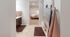 Inviting apartment bathroom with modern fixtures, plush towels, and view into a cozy, carpeted bedroom.