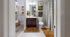 Inviting bathroom with modern decor, featuring a stylish vanity, warm lighting, and a spacious walk-in closet.