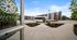 Inviting apartment complex exterior showcasing modern architecture, well-maintained landscaping, and easy access with a community shuttle bus.