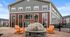 Charming apartment exterior with vibrant orange chairs around a cozy fire pit, perfect for relaxation and social gatherings.