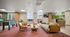 Inviting modern communal lounge featuring a cozy seating area, stylish decor, and a foosball table, perfect for relaxation and entertainment.