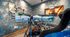 Luxurious gaming setup in a vibrant room with a triple-screen racing simulator and dynamic wall art.