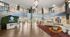 Luxurious apartment lobby with modern decor, cozy seating, and stylish lighting, featuring The Feywild branding.