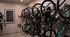 Modern apartment bike storage room featuring multiple bicycles neatly mounted on wall racks, with sleek design and efficient use of space.