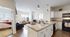 Modern open-plan layout featuring a stylish kitchen, cozy living area, and bright bedroom, ideal for contemporary living.