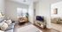 Chic and cozy living room with modern decor, featuring a plush sofa, stylish armchair, and abundant natural light, leading into a serene bedroom.