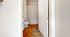 Inviting bathroom with elegant beige shower curtain, modern vanity, and plush orange rugs creating a cozy atmosphere.
