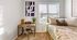 Cozy bedroom with a stylish desk and modern artwork beside a sunlit window, perfect for relaxation and productivity.