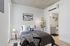 Bright and modern bedroom with sleek minimalistic design, cozy bed, and adjacent stylish bathroom.