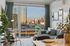 Modern apartment living room featuring chic decor, a cozy seating area, and expansive cityscape views through large windows.