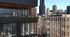 Modern cityscape view from a luxurious apartment balcony, showcasing a stylish exterior with large glass windows for natural light and breathtaking skyline vistas.
