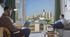 Modern apartment with stunning cityscape view, featuring a cozy living space ideal for relaxation and productivity.