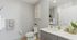 Bright and modern bathroom with sleek fixtures, elegant vanity, and tasteful decor, exuding a sense of luxury and relaxation.