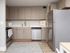 Model kitchen at our apartments for rent in New Brunswick, featuring wood grain floor paneling and stainless steel appliances