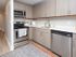 Model kitchen at our apartments for rent in New Brunswick, featuring wood grain floor paneling and stainless steel appliances