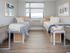 Contemporary bedroom with two single beds, large window with abundant natural light, and stylish decor.