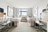 Bright and modern shared bedroom with stylish decor, featuring two cozy single beds, sleek workspace, and large window with city views.