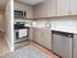 Modern kitchen with sleek cabinetry, stainless steel appliances, and a spacious countertop, ideal for culinary creativity.