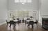 Elegant dining area with modern round tables, sleek chairs, and abundant natural light from large windows, featuring a cozy fireplace and contemporary decor.