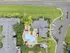 Stunning aerial view of a modern apartment complex showcasing a luxurious central pool area surrounded by lush greenery and stylish architecture.