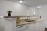 Elegant kitchen with modern design, featuring sleek countertops, a double sink, and ample cabinetry, perfect for culinary creativity.