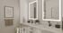 Contemporary ensuite bathroom with double vanity, illuminated mirrors, black fixtures, white cabinetry, and clean modern finishes.