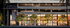 Contemporary apartment facade with illuminated balconies and vibrant greenery, showcasing modern urban elegance.