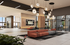 Modern and inviting apartment lobby featuring chic pendant lighting, stylish seating areas, and expansive glass windows offering natural light.