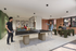 Modern recreational room with a lively table tennis game and a cozy seating area, perfect for socializing and relaxation.