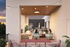 Chic rooftop lounge featuring cozy seating, string lights, and a sunset view, perfect for social gatherings.