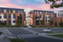 Charming modern apartment building with brick facade and large windows, set against a vibrant sunset sky.