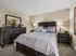 Apartment bedroom featuring plush carpeting, neutral walls, and space for full bedroom furniture.