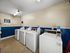 Community laundry room with multiple washers for resident use