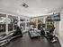 Apartment community fitness center with treadmill, elliptical, and stationary bike