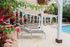 Poolside Lounge Seating with Shaded Pergola and Lush Landscaping