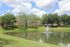 Scenic Pond with Fountain and Apartment Homes Surrounded by Green Space
