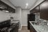 Renovated apartment kitchen with granite countertops and stainless steel appliances