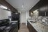 Two-bedroom apartment kitchen with granite countertops and modern backsplash
