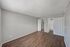 Two-bedroom apartment primary bedroom with wood-style flooring and ensuite bathroom access