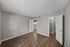 One-bedroom apartment bedroom with large window and wood-style flooring