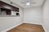 Spacious dining area with wood-style flooring, chair rail molding, and kitchen pass-through bar.