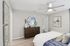 Bedroom with ceiling fan, wood-style flooring, and walk-in closet