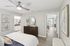 Bedroom with ceiling fan, wood-style flooring, and walk-in closet